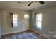 Living room featuring a door and two windows with curtains at 153 Saluda St, Chester, SC 29706