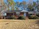 Brick ranch house with a covered porch, situated on a spacious lot with mature trees at 160 Williamson St, Troy, NC 27371