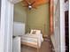 Bright bedroom with exposed brick wall and large windows at 201 S Hoskins Rd # 136, Charlotte, NC 28208