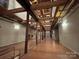 Long hallway with exposed wood beams and hardwood floors at 201 S Hoskins Rd # 136, Charlotte, NC 28208