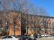 Brick building with parking and mature trees at 201 S Hoskins Rd # 136, Charlotte, NC 28208