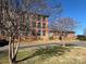 Brick building with landscaping and clear blue sky at 201 S Hoskins Rd, Charlotte, NC 28208