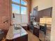 Kitchen features granite countertops, stainless steel appliances, and exposed brick at 201 S Hoskins Rd # 136, Charlotte, NC 28208
