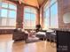 Sunlit living room with hardwood floors and exposed brick at 201 S Hoskins Rd, Charlotte, NC 28208