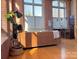 Living room with hardwood floors, exposed brick walls and large windows at 201 S Hoskins Rd # 136, Charlotte, NC 28208