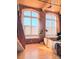 Living area with hardwood floors, exposed brick walls and large windows at 201 S Hoskins Rd # 136, Charlotte, NC 28208