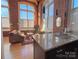 Spacious living room with exposed brick walls and large windows at 201 S Hoskins Rd # 136, Charlotte, NC 28208
