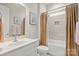 This charming bathroom features a shower-tub combo, modern fixtures, and wall art at 253 Stone Mountain Way, Denver, NC 28037