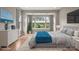 Beautiful bedroom with a dresser, decor, and a queen bed next to a window looking out on the lawn with a large, cozy blanket at 253 Stone Mountain Way, Denver, NC 28037