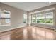 Bright bedroom featuring hardwood floors, neutral walls, and large windows offering serene views of the surrounding greenery at 253 Stone Mountain Way, Denver, NC 28037