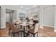 Staged dining room with a marble table and seating for six, illuminated by recessed lighting at 253 Stone Mountain Way, Denver, NC 28037