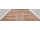 Close-up of natural hardwood flooring with white baseboards and neutral colored wall at 253 Stone Mountain Way, Denver, NC 28037