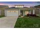 Charming single-story home featuring a one car garage, manicured lawn, and colorful landscaping at 253 Stone Mountain Way, Denver, NC 28037