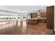 An open concept great room with hardwood floors and an adjacent island kitchen at 253 Stone Mountain Way, Denver, NC 28037