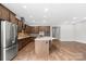 Spacious kitchen features a center island, stainless steel appliances, and hardwood flooring at 253 Stone Mountain Way, Denver, NC 28037