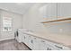 Functional laundry room featuring modern washer/dryer, sink, and ample counter space at 253 Stone Mountain Way, Denver, NC 28037