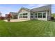 A well-maintained backyard featuring a lush lawn and a paver patio adjoining the home at 253 Stone Mountain Way, Denver, NC 28037