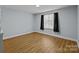 Bright bedroom with wood floors and window at 3144 Central Ave # F, Charlotte, NC 28205