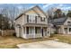 Two-story tan house with white porch and blue door, located on a tree-lined street at 3249 Ian Patrick Ave, Kannapolis, NC 28083