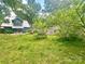 Expansive backyard with mature trees surrounding a charming home at 3317 Ritch Ave, Charlotte, NC 28206