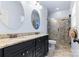 Bathroom featuring a double vanity with dark cabinets and walk-in shower with glass door at 3317 Ritch Ave, Charlotte, NC 28206