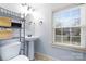 Bathroom featuring a pedestal sink, modern fixtures, and a window with blinds at 3317 Ritch Ave, Charlotte, NC 28206