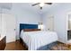 Charming bedroom with a blue headboard, ceiling fan, and hardwood floors at 3317 Ritch Ave, Charlotte, NC 28206