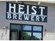Heist Brewery's exterior featuring its bold sign and entrance at 3317 Ritch Ave, Charlotte, NC 28206