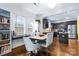 Eat-in kitchen/dining room featuring dark cabinetry, stainless steel appliances, hardwood floors, and ample natural light at 3317 Ritch Ave, Charlotte, NC 28206