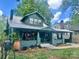 Inviting green home showcasing a covered porch, manicured landscaping, and an electric vehicle charging station at 3317 Ritch Ave, Charlotte, NC 28206