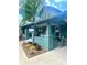 Inviting covered front porch featuring brick columns, comfortable seating, and a charming garden with vibrant flowers at 3317 Ritch Ave, Charlotte, NC 28206