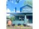 Charming home featuring a covered front porch with inviting greenery, brick accents, and a cozy, welcoming atmosphere at 3317 Ritch Ave, Charlotte, NC 28206