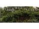 A wrought-iron sign marks the entrance to the lush McGill Rose Garden at 3317 Ritch Ave, Charlotte, NC 28206
