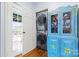 Convenient laundry area with stacked washer and dryer and a charming, painted cabinet at 3317 Ritch Ave, Charlotte, NC 28206