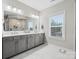 Bathroom with double vanity, gray cabinets, and marble tile floor at 443 Brier Knob Dr, Fort Mill, SC 29715