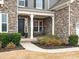 Inviting front porch with rocking chairs and stone facade at 443 Brier Knob Dr, Fort Mill, SC 29715