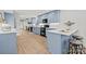 Renovated kitchen featuring light blue cabinets, quartz countertops, and stainless steel appliances at 7016 Foxworth Dr, Charlotte, NC 28226