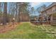 Landscaped backyard with stone pathway leading to deck at 7282 James Ct, Denver, NC 28037