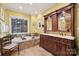 Luxurious bathroom with double vanity, soaking tub, and large mirror at 7282 James Ct, Denver, NC 28037