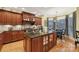 Spacious kitchen featuring granite island, custom cabinetry, and hardwood floors at 7282 James Ct, Denver, NC 28037