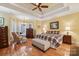 Spacious main bedroom with tray ceiling, hardwood floors, and ample natural light at 7282 James Ct, Denver, NC 28037
