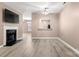 Living room with a fireplace, hardwood floors, and a view into the kitchen at 729 Torrey Pines Ln, Fort Mill, SC 29715