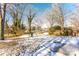 Large backyard with snow, trees, and playset at 751 N Miller Ave, Statesville, NC 28677