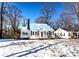 Charming ranch home with snow-covered lawn and black shutters at 751 N Miller Ave, Statesville, NC 28677