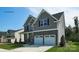 Two-story house with gray siding, stone accents, and a two-car garage at 8016 Plymouth Dr, Sherrills Ford, NC 28673