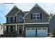Two-story house with gray siding, stone accents, and a two-car garage at 8016 Plymouth Dr, Sherrills Ford, NC 28673
