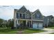 Two-story house with gray siding, stone accents, and a two-car garage at 8016 Plymouth Dr, Sherrills Ford, NC 28673