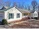 House exterior showcasing a metal roof and partial garage view at 9409 Indian Trail Fairview Rd, Indian Trail, NC 28079