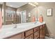 Bright bathroom with double sinks, spacious vanity, large mirror, and tiled shower, offering a clean and modern feel at 9415 Rosalyn Glen Rd, Cornelius, NC 28031