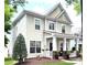 Charming two-story home featuring a welcoming front porch, well-manicured lawn, and classic architectural details at 9415 Rosalyn Glen Rd, Cornelius, NC 28031